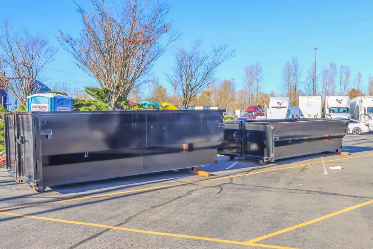 Professional dumpster rental service with roll-off container on residential driveway in Lafayette